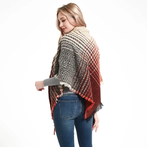 Detail of knit triangle shawl with tassels showing red and orange geometric patterns