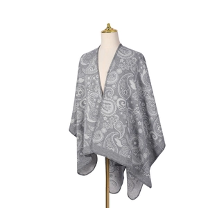Detailed view of grey wool shawl with white paisley and floral jacquard patterns