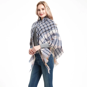 Detailed view of women's soft plaid shawl with fringe tassels in light grey and navy blue