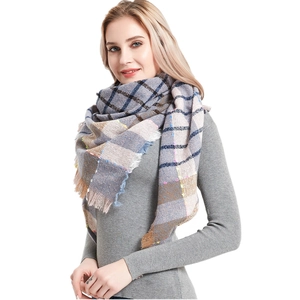 Detailed view of plaid thick shawl scarf with fringe edges and classic check pattern