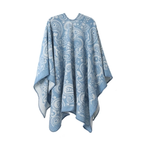 Detail of light blue knit pashmina shawl with white paisley pattern and hemmed edges