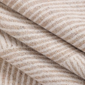 Vue macro de la maille jacquard beige et blanche avec texture douce en faux cachemire