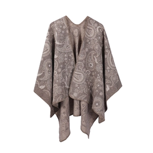 Detail of tan paisley wool shawl showing intricate ethnic jacquard weave texture