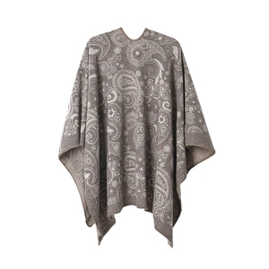 Close-up of intricate paisley jacquard pattern on soft wool-blend knit shawl in taupe