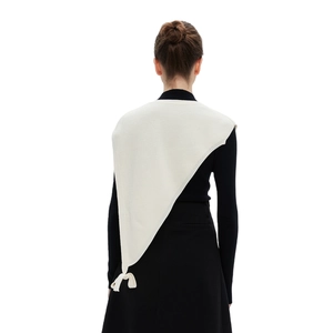 Minimalist cream knit triangle shawl with ribbed texture shown from the back on a model