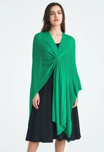 Detail of light green knit shawl featuring twisted front design and textured fabric