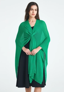 Close-up of green knit shawl featuring intricate crochet texture and front twist knot detail