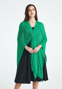 Detail view of grass green knitted shawl with elegant front twist knot and draped layers