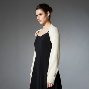 Minimalist white knit shrug cardigan for women shown from a 45-degree angle in studio