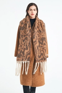 Close-up of wavy pattern scarf and camel wool coat with long fringe details for winter