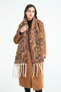 Detail of water-ripple patterned bouclé jacquard scarf with long fringe tassels