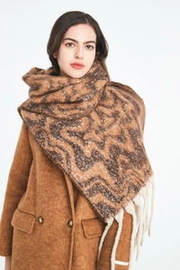 Detail of brown water ripple jacquard scarf with soft textures and white tassel fringe