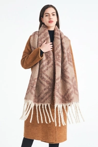 Close-up of thick checkered knit scarf with long cream tassels on brown wool coat