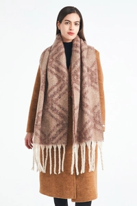Detail of winter scarf with brown geometric jacquard pattern and thick white fringes