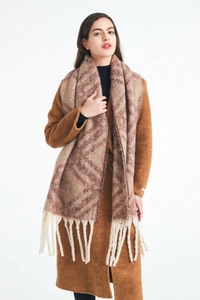 Detail shot of chunky plaid scarf with neutral earth tones and thick cream fringes