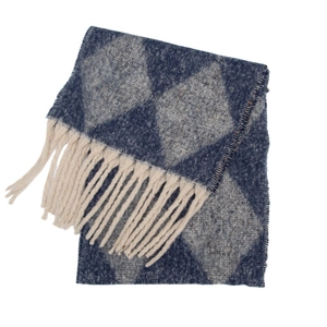 Macro shot of argyle knit scarf featuring navy blue pattern and cream white tassels
