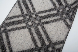 Detail of grey and white plaid knit scarf texture with soft faux mohair wool fibers