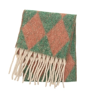 Detailed view of the diamond pattern knit fabric and long cream fringe of the winter scarf