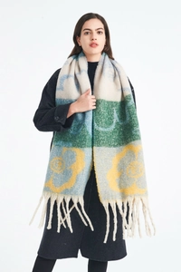 Close-up of thick floral jacquard scarf with mohair texture and long fringe details