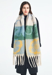 Detail of soft jacquard knit scarf with bold floral patterns and knotted fringe tassels
