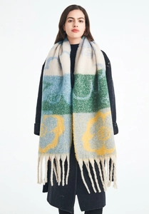 Detail of soft jacquard knit scarf with colorful floral patterns and thick fringe tassels