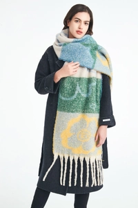 Detail of multi-color knit scarf featuring yellow flower pattern and thick fringe tassels