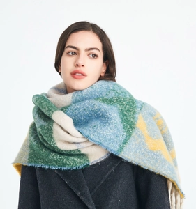 Detail of multi-color jacquard scarf showing abstract geometric knit patterns and soft texture