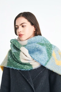 Close-up of winter thick shawl scarf with colorful plaid pattern and soft fuzzy texture
