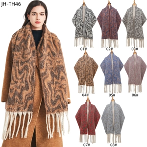 Knitted wave pattern scarf with long fringe in multiple winter colors and soft texture