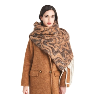 Women's autumn winter thick scarf with wavy pattern and long tassels over brown coat
