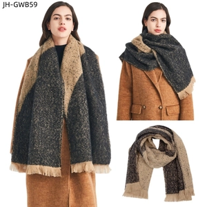 Detail view of thick winter scarf with bicolor jacquard pattern and fringe trim