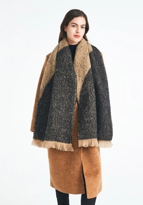 Close-up of thick winter shawl scarf with dark grey and camel color block and fringe