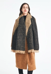 Detail of color-block knit scarf with tassel fringe on thick cashmere-like shawl