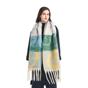 Winter long scarf with colorful floral jacquard pattern and fringes on white background