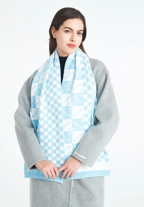Detail view of the sky blue and white checkered knit texture and ribbed cuff finish