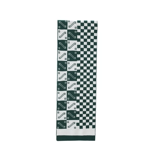Detailed view of the checkered knit scarf showing dark green ribbing and soft texture