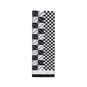 Detailed view of black and white checkerboard knit scarf with geometric patterns