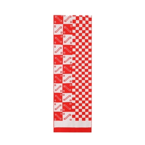 Detail of red and white checkered knit scarf showing premium jacquard texture and rib edges
