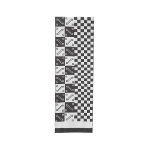 Detail of knit scarf showing black and white checkerboard pattern and ribbed edges