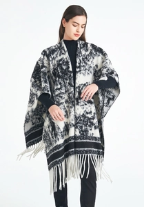 Detailed close-up of ink painting jacquard pattern and long tassel hem on the knit shawl