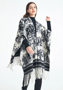 Detail of black and white ink painting knit shawl with elegant long tassel hem