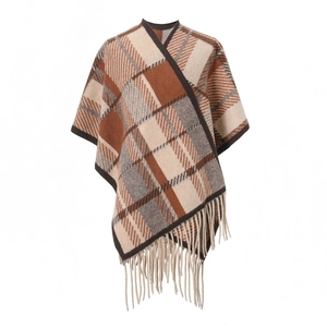Detail of classic plaid shawl featuring brown and grey knit pattern and long tassel hem