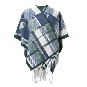 Detail of forest green and navy plaid shawl featuring soft knit texture and long fringe