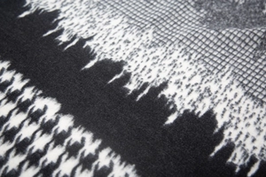 Macro detail of soft black and white houndstooth jacquard fabric with brushed texture