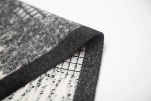Detail of soft knit texture and fringe on black and white jacquard patterned shawl