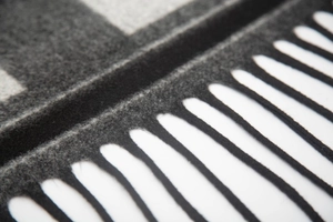 Close-up of thick ink-wash jacquard fabric with elegant tassel fringe details