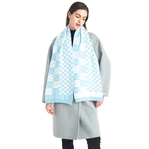 Knitted checkerboard scarf in light blue and white with geometric patterns for winter