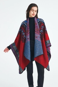 Detail of red Bohemian knit poncho with ethnic jacquard patterns and sharp textures