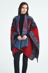 Detailed view of ethnic jacquard knit pattern and texture on red women's shawl cape