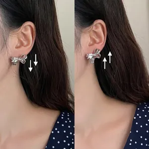 Silver bow earrings comparison showing the corrective effect of flower shaped ear backings